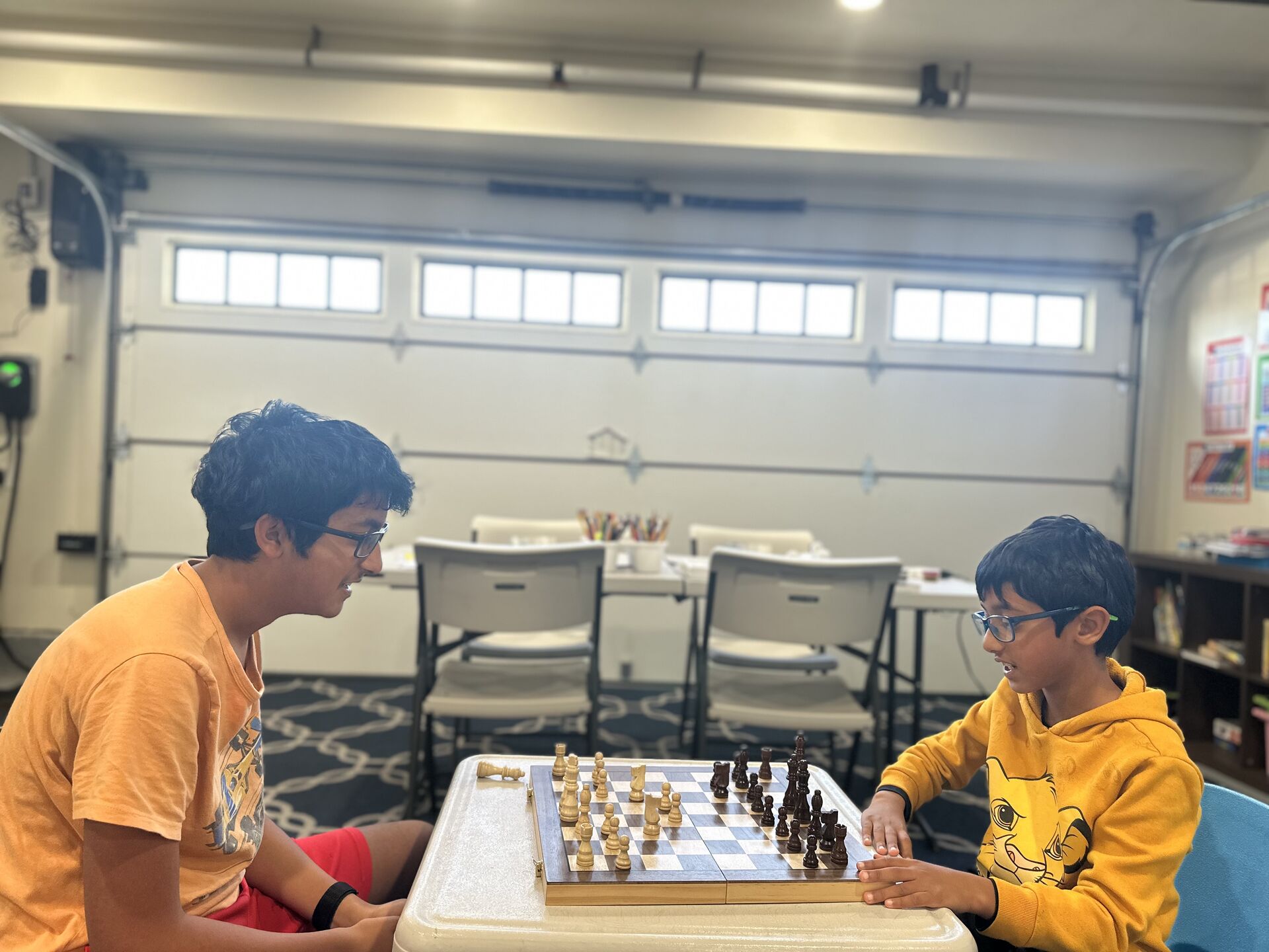Children engaged in educational chess activities at Symphony Childcare